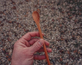 Long slender handmade wood cocktail stirring spoon with dark grain running the full length