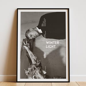 May include: Black and white poster with the title "WINTER LIGHT" and a man looking down at a sculpture. The poster lists the names of the actors and director.