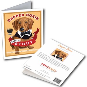 May include: A greeting card featuring a cartoon dachshund wearing a tuxedo and holding a glass of beer. The card has a vintage-style design with the text "Dapper Doxie Short 'N' Stout 100% Barkanol by Volume". The back of the card has a fun fact about dachshunds.