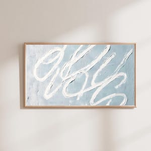 May include: Abstract painting with white brushstrokes on a light blue background. The painting is framed in a light wood frame.