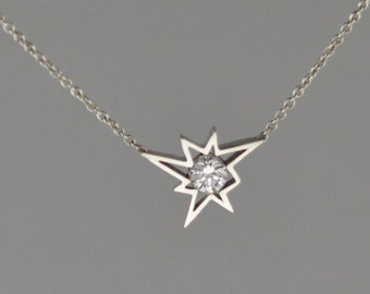 0.25 carat Diamond set in 18 kt white gold star shape pendant with chain attached.