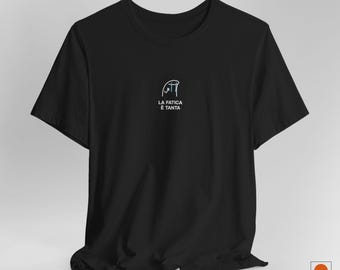 May include: Black t-shirt with a simple graphic design of a person with a thought bubble that says "La fatica e tanta".