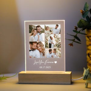May include: A lighted photo display with a wooden base. The display features multiple photos of a couple, with the words "Love You Forever" and the date "08.17.2025" printed on the front. The display is lit from within.