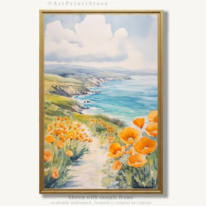 The image is a watercolor painting depicting a scenic coastal landscape with a path leading through a field of vibrant orange flowers. The painting is framed and displayed on a wall, showcasing the artist's skill and attention to detail in capturing the beauty of the natural surroundings.