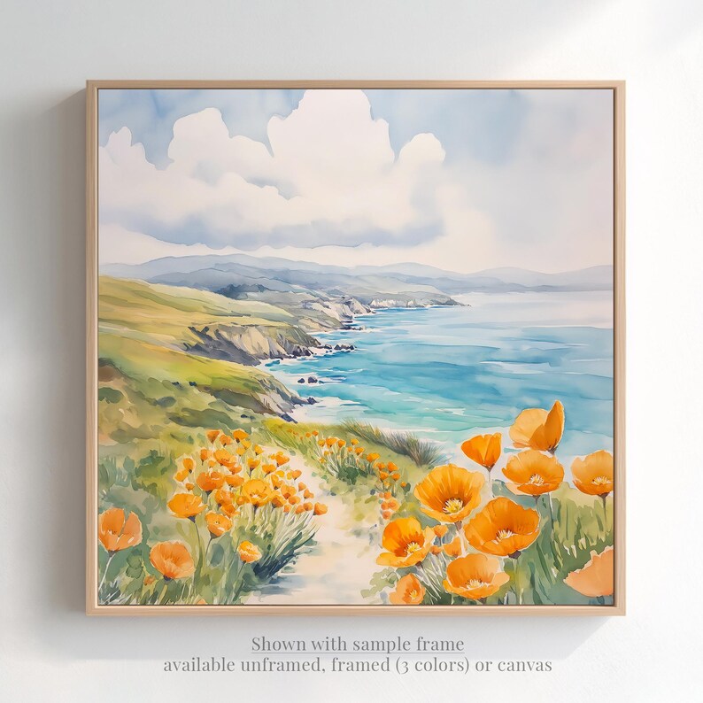 The image is a watercolor painting depicting a scenic coastal landscape with a path leading through a field of vibrant orange flowers. The painting is framed and displayed on a wall, showcasing the artist's skillful use of color and brushstrokes to capture the beauty of the natural surroundings.