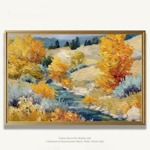 May include: An oil painting of a landscape with a river, featuring trees with yellow and orange foliage. The artwork is framed in a gold-colored frame. The painting has a warm color palette, with blues, greens, and yellows. The text at the bottom says "Frame shown for display only".