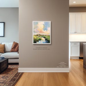 a living room with a large painting of a landscape hanging on the wall.