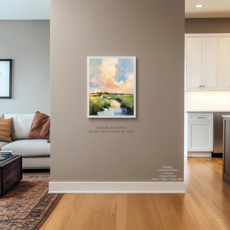 a living room with a large painting of a landscape hanging on the wall.