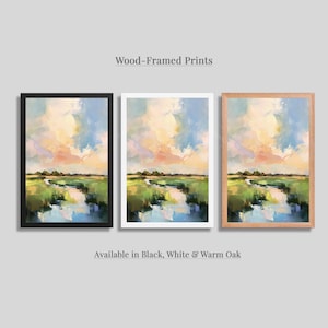 three framed prints of a landscape painting, each in a different frame color: black, white, and warm oak.