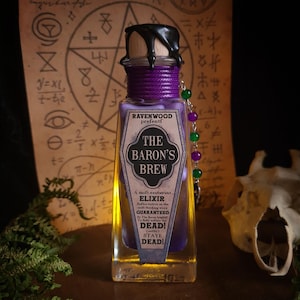 May include: A square glass bottle filled with a yellow and purple liquid, labeled "The Baron's Brew." The bottle has a wooden stopper sealed with black wax and is wrapped with purple twine. A beaded charm with green and purple beads hangs from the bottle.
