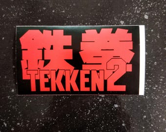 TEKKEN 2-klistermärke - 10 x 5 cm [Väderbeständig vinyldekal till stötfångaren] [Namco fightingspel]