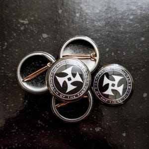 May include: Four black and white button badges with the text "The Process, Church of the Final Judgment" and a cross symbol.