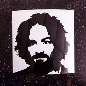 May include: Black and white silhouette of a man with long hair and a beard. The image is a sticker.