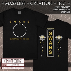 May include: Black adult tee shirts with the band name "SWANS" in yellow. One shirt has a white circle and the text "SOUNDTRACKS FOR THE BLIND". The other shirt has the text "SWANS" and two yellow eyes.