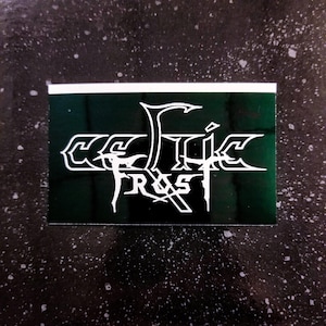 May include: A green and white sticker with the text "Celtic Frost" in a stylized font.