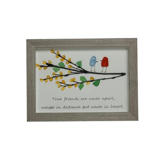 May include: A framed artwork featuring a branch with yellow and green glass leaves and two glass birds, one blue and one red. The quote "True friends are never apart, maybe in distance but never in heart." is written below the branch.