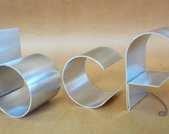 Metal letters/Personalized/ lowercase initials/ freestanding signage goes w/our regular letters.  Names/words/unique gifts