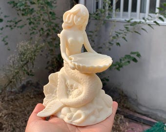Ivory Tagua Nut carved mermaid sitting on stones holding big scallop shell.