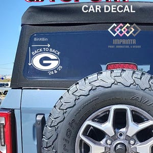 May include: A blue car with a car decal that reads "GA SPORT CAR DECAL". The decal includes a white and black "G" logo with the text "BACK TO BACK" and "'24 & '25". The decal is 20cm x 20cm.