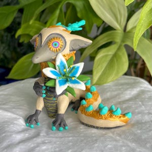 Light Dragon holding Silent Princess Flower- Glow in the dark Clay Figure- Handmade Cozy Desk Buddy - Inspired by Zelda Tears of the Kingdom
