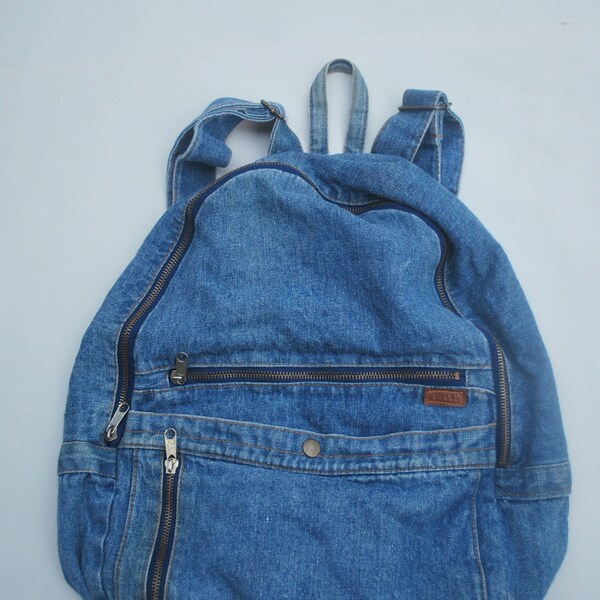 Vintage Denim stone washed backpack .jean bag .zippers and compartments. by Shane the best denim hustler known to man