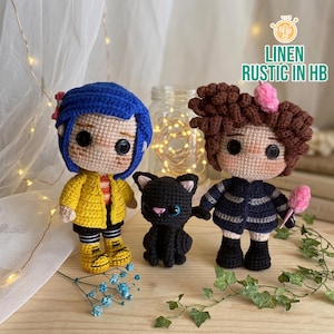 May include: Handmade crochet dolls depicting characters from a film, including a girl in a yellow coat and blue hair, a girl in a dark blue outfit, and a black cat. The dolls have button eyes and yarn hair. The text "LINEN RUSTIC IN HB" is visible.