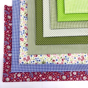 May include: A collection of fabric swatches in various patterns and colors. The fabrics include floral, gingham, polka dot, and striped designs in shades of red, blue, green, and white. Ideal for quilting or crafting projects.