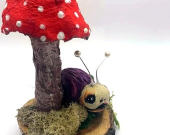 Polymer clay snail on mushroom