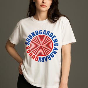 May include: White t-shirt with a circular graphic featuring the text "SOUNDGARDEN" in blue and red. The graphic has a spiral design in the center. The shirt is a crew neck style.