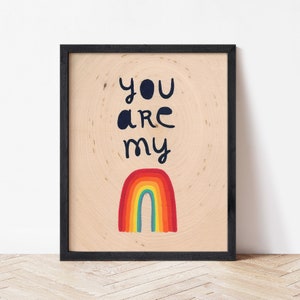 May include: A framed print with a rainbow and the text "You are my" in black lettering on a light wood background.