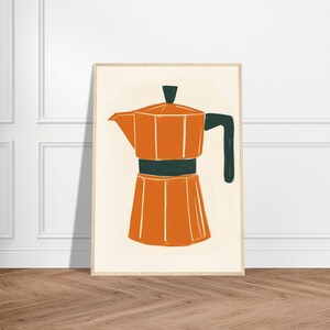 May include: An orange and dark green coffee pot illustration in a wooden frame. The artwork features a stylized depiction of a stovetop espresso maker, with a light beige background. The coffee pot is orange with a dark green handle and band.