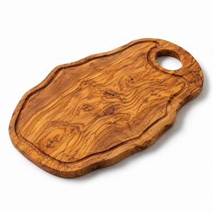 May include: A wooden serving board with a natural, irregular edge and a prominent wood grain pattern. The board features a circular cutout handle at one end and a shallow, carved groove that follows the perimeter of the central surface area.
