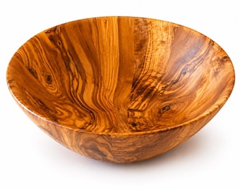 May include: A round wooden bowl featuring a prominent, swirling grain pattern in shades of golden brown, amber, and dark brown. The interior surface is smooth and polished, showcasing the natural organic texture and knots of the wood grain.