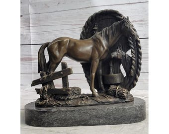 May include: Bronze horse sculpture featuring a detailed depiction of a horse standing near a wooden fence and a water trough. The sculpture is mounted on a dark gray marble base, showcasing the horse's form and texture.