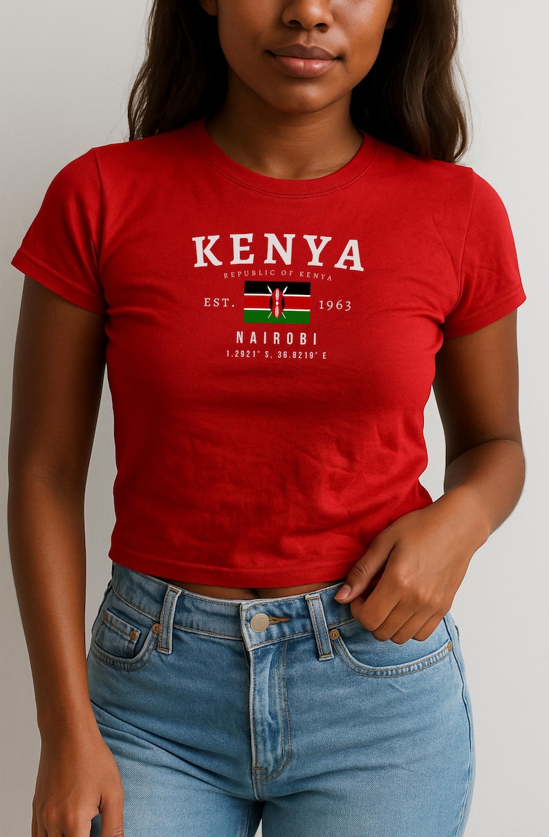 May include: Red cropped t-shirt with a white graphic print of the Kenyan flag and the text "KENYA REPUBLIC OF KENYA EST. 1963 NAIROBI 1.2821&deg; S, 36.8219&deg; E"