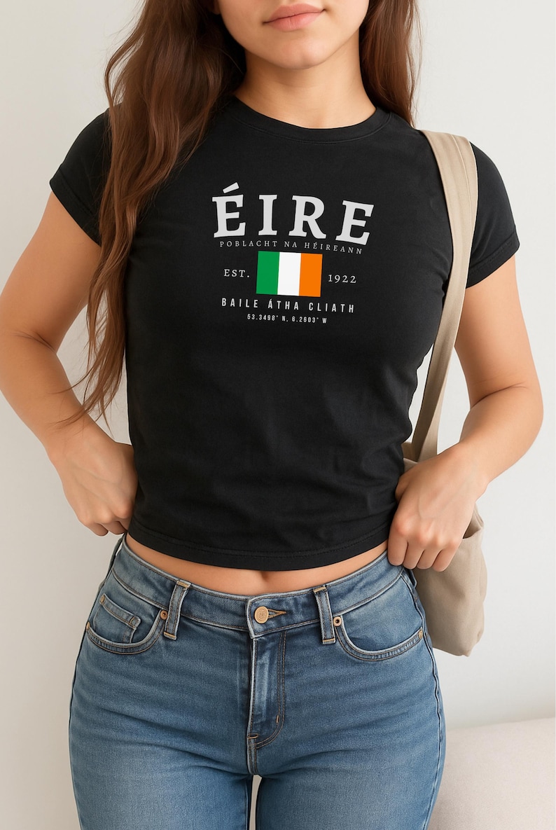 May include: Black t-shirt with a white graphic print of the Irish flag and the text "&Eacute;IRE POBlacht NA h&Eacute;ireann EST. 1922 BAILE &Aacute;THA CLIATH 53.3406&deg; N, 6.2603&deg; W"