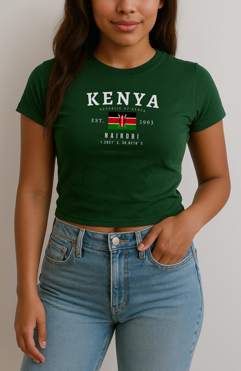 May include: A green t-shirt with a white graphic print of the text "KENYA REPUBLIC OF KENYA EST. 1963 NAIROBI 1.2921&deg; S, 36.8219&deg; E" and a small image of the Kenyan flag.