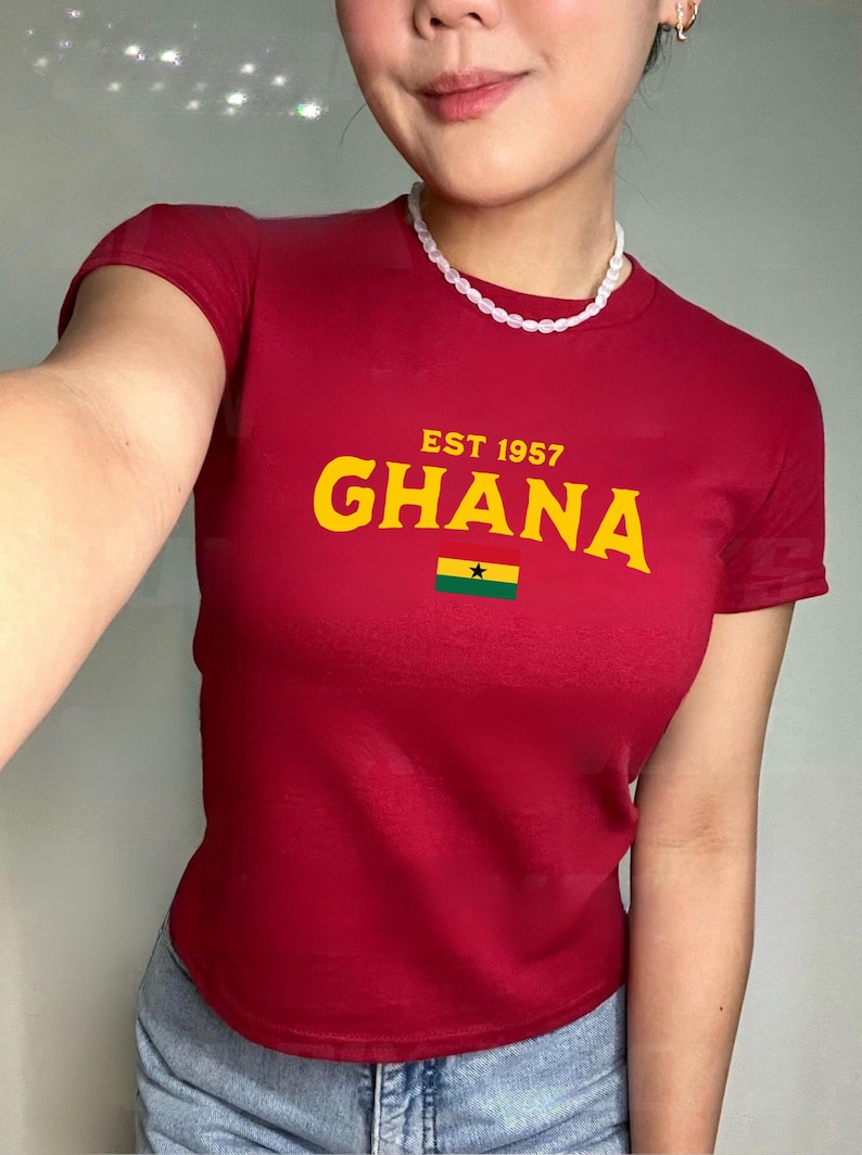 May include: A red t-shirt with a yellow graphic that says "EST 1957 GHANA" and a small Ghanaian flag.