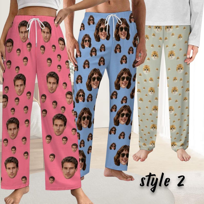 May include: Three pairs of pajama trousers are shown. One is pink with a face pattern, another is light blue with a face pattern, and the third is light green with a cat face pattern. The text "style 2" is at the bottom.