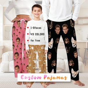 May include: Custom pyjamas in pink, brown, and black, with repeating patterns of faces and pets. The image shows three people wearing the pyjamas. The text on the image says "1-8 faces, 49 colours for free" and "Custom Pajamas."
