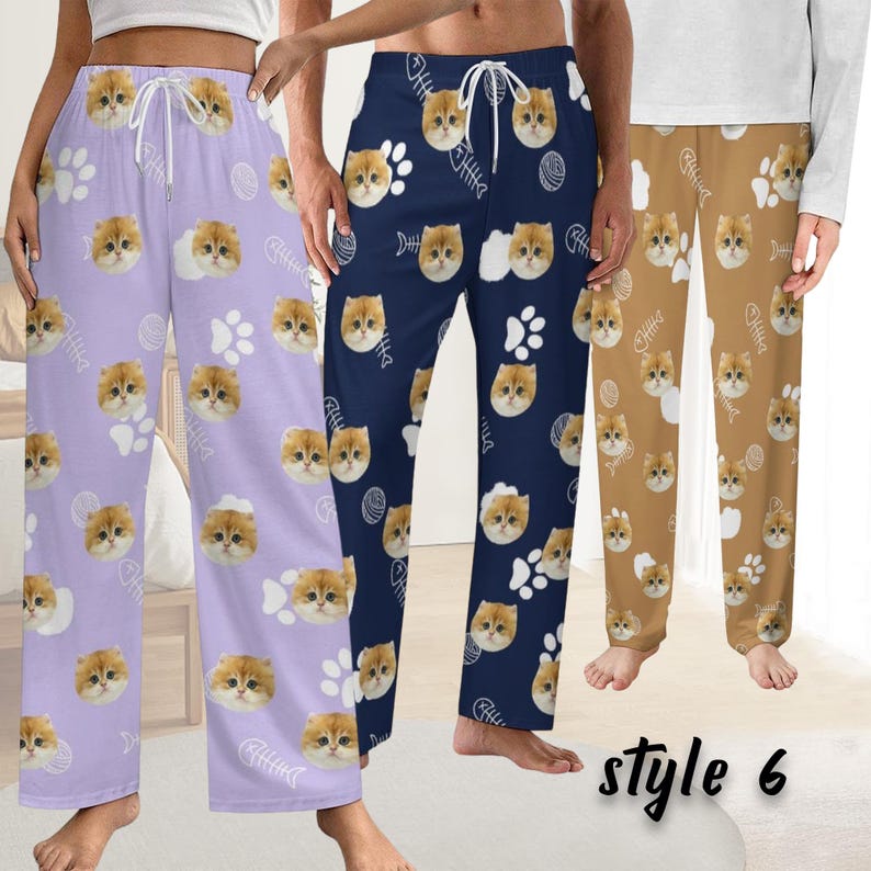 May include: Three pairs of pajama trousers in lavender, navy blue, and tan. Each pair has a repeating pattern of cat faces, paw prints, and fish bones. The text "style 6" is visible.