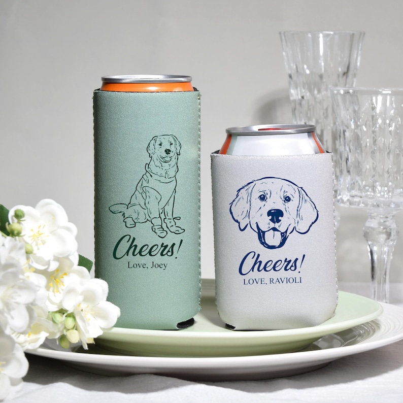May include: Two beverage can coolers. One is light green with a dog illustration and the text "Cheers! Love, Joey". The other is white with a dog illustration and the text "Cheers! Love, Ravioli".