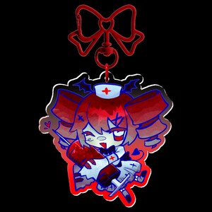 May include: A red and white cartoon nurse charm with a red bow-shaped clasp. The charm features a nurse with red hair, a white uniform, and a syringe. The charm has a red outline and a black background.