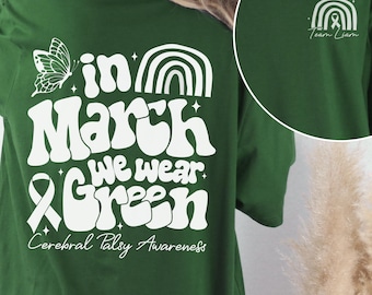 May include: Green t-shirt with a white butterfly, rainbow, and the text "in March we wear green" and "Cerebral Palsy Awareness".
