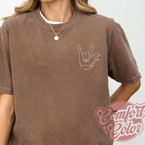 Love Needs No Words autism shirt with hand sign outline. Comfortable awareness tee for autism support teams, SPED teacher gift, or autism awareness month apparel.