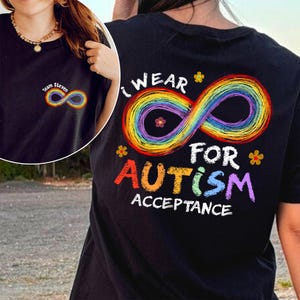 May include: Black t-shirt with a rainbow infinity symbol and the text "I Wear For Autism Acceptance." A smaller version of the symbol and the text "Team Steven" is on the front. The design includes colorful flowers.