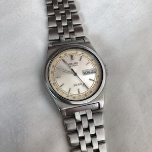 Vintage Seiko Quartz SQ 100 Day Date 35mm Watch 7N43-8001 Stainless Steel Japan
