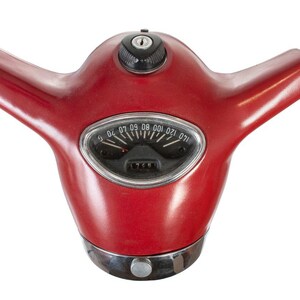 May include: Red vintage scooter handlebar with a chrome speedometer and a keyhole. The speedometer has numbers from 0 to 120.