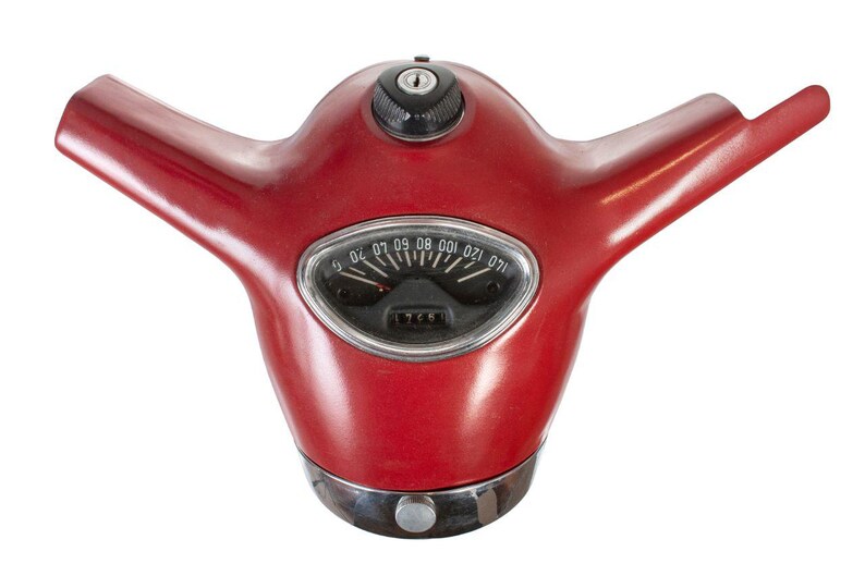 May include: Red vintage scooter handlebar with a chrome speedometer and a keyhole. The speedometer has numbers from 0 to 120.