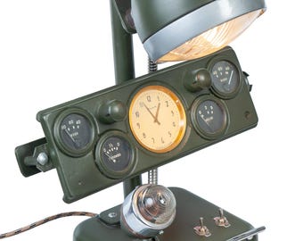 A military-style lamp made from components of Soviet-era military equipment. The gadget also features a stand and a container for cigarettes and alcohol.
